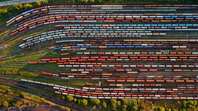 An overhead view of trains lined up in a rail yard.